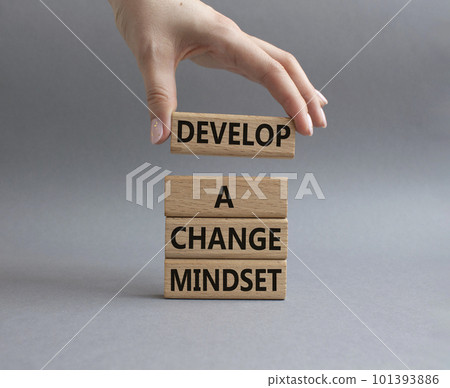 Develop a change mindset symbol. Concept words Develop a change mindset on wooden blocks. Beautiful grey background. Businessman hand. Business and Develop a change mindset concept. Copy space. 101393886