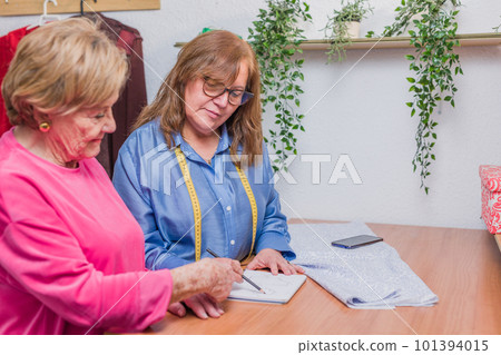 Patternmaking seamstress making a handmade dress. clothes manufacturing. mature, senior woman latin 101394015