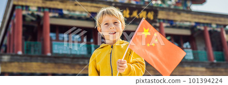 Enjoying vacation in China. Young boy with national chinese flag on the background of the old Chinese street. Travel to China concept. Visa free transit 72 hours, 144 hours in China BANNER, LONG 101394224