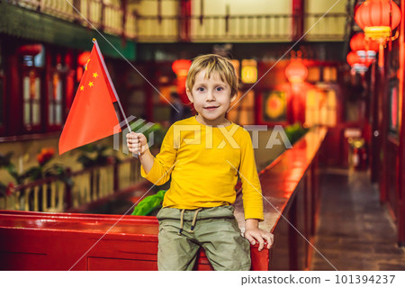 Enjoying vacation in China. Happy tourist boy with a Chinese flag on a Chinese background. Travel to China with kids concept. Visa free transit 72 hours, 144 hours in China 101394237