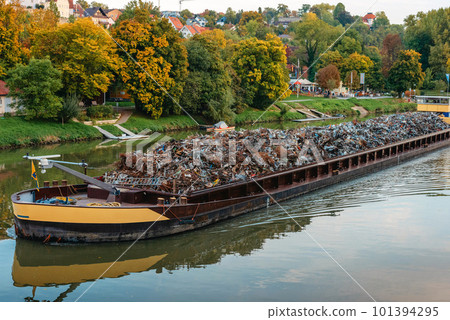 Transportation industry. Ship barge transports scrap metal and sand with gravel. Barge loaded with scrap metal is on the roadstead. Scrap metal transportation by water. Barge laden by metal salvage Transportation industry. Ship barge transports scrap metal and sand with gravel. Barge loaded with scrap metal is on the roadstead. Scrap metal transportation by water. Barge laden by metal salvage 101394295