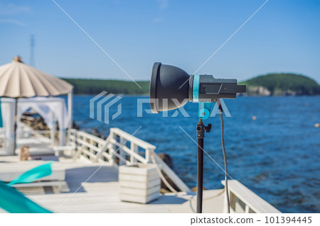 Cinema lights on a commercial video production shoot with lounge zone by the sea 101394445