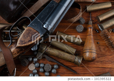 Antique 16-gauge break-action smooth-bored shotgun with brass cases and accessories for cartridge reloading. 101395322