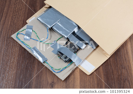Mail bomb IED. Hand made Improvised Explosive Device with plastic explosive C-4 and cell phone module in envelope Mail bomb IED. Hand made Improvised Explosive Device with plastic explosive C-4 and cell phone module in envelope 101395324