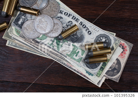 Old west period US banknotes and silver certificates with silver dollar coins and .45 caliber revolver ammunitions Old west period US banknotes and silver certificates with silver dollar coins and .45 caliber revolver ammunitions 101395326