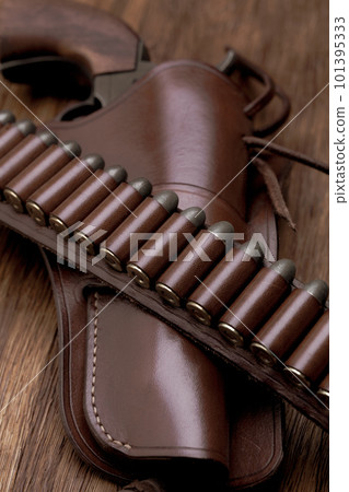 Old west leather gun belt with ammnunitions and revolver in holster Old west leather gun belt with ammnunitions and revolver in holster 101395333