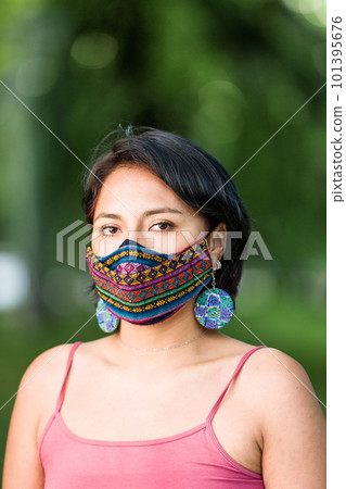 Latin America Bolivian woman with traditional pattern cloth mask. Handmade quechua native textile face mask for covid-19, coronavirus protection 101395676