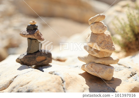 Pyramid stones balance on the sand rock. The object is in focus, the background is blurred Pyramid stones balance on the sand rock. The object is in focus, the background is blurred 101397016