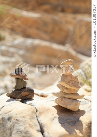 Pyramid stones balance on the sand rock. The object is in focus, the background is blurred Pyramid stones balance on the sand rock. The object is in focus, the background is blurred 101397017