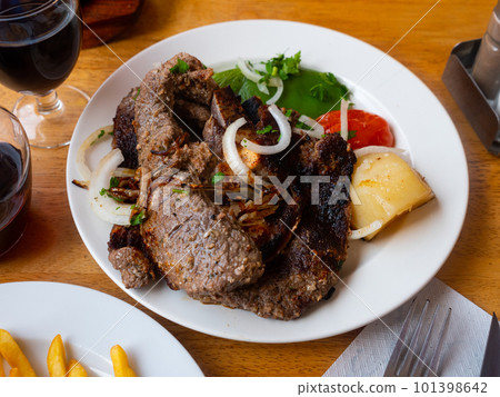 Beef rib served with potatoes and vegetables Beef rib served with potatoes and vegetables 101398642