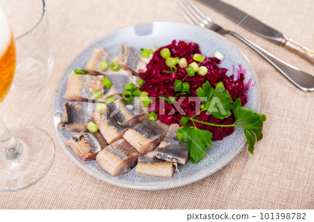 Lightly salted herring with beets served on platter 101398782