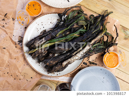 A traditional catalan dish of charred calcot onion and romesco sauce A traditional catalan dish of charred calcot onion and romesco sauce 101398817