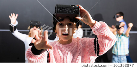 Surprised tween girl in VR headset playing virtual reality games Surprised tween girl in VR headset playing virtual reality games 101398877