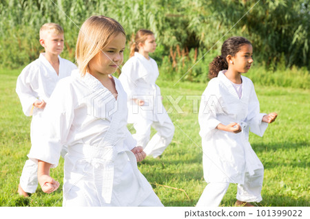 Barefoot kids doing kata Barefoot kids doing kata 101399022