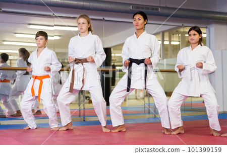 Young teenagers happy to attend karate class on self defense Young teenagers happy to attend karate class on self defense 101399159