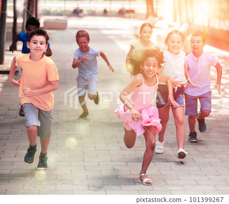 Happy children running in race and laughing outdoors Happy children running in race and laughing outdoors 101399267