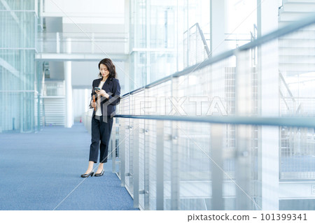 Young business woman with a smartphone Young business woman with a smartphone 101399341