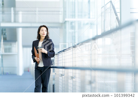 Young business woman with a smartphone Young business woman with a smartphone 101399342