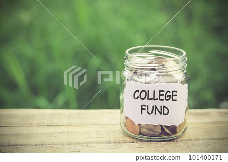 Money in the jar on wooden table Money in the jar on wooden table 101400171