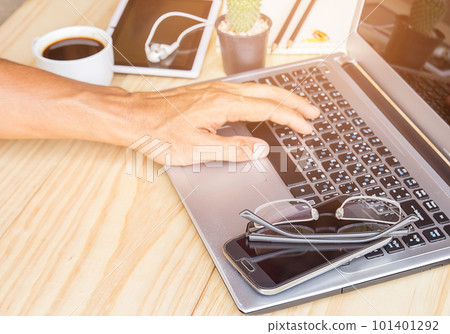 Business man is working by using a laptop computer 101401292