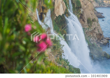 Lower Duden Falls drop off a rocky cliff falling from about 40 m into the Mediterranean Sea in amazing water clouds. Tourism and travel destination photo in Antalya, Turkey. Turkiye. 101401909