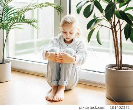 Lonely sad girl near the window. Lonely sad girl near the window. 101402271