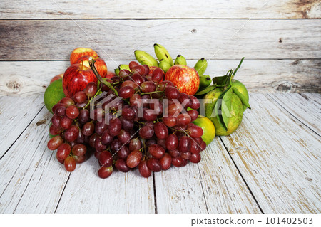 Various of fruits with Red grape, red apple and green orange on wooden background Various of fruits with Red grape, red apple and green orange on wooden background 101402503