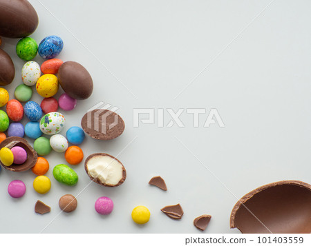 Colorful and chocolate easter eggs with sweet dragee on white background 101403559