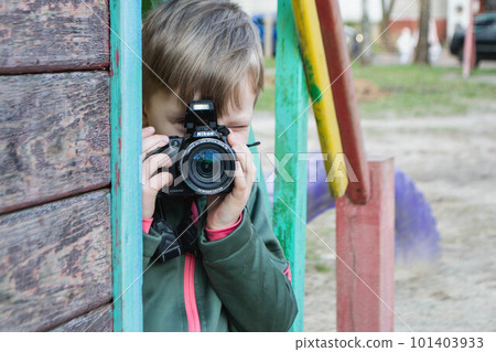 kid on the street in a jacket with an film camera. High quality photo kid on the street in a jacket with an film camera. High quality photo 101403933