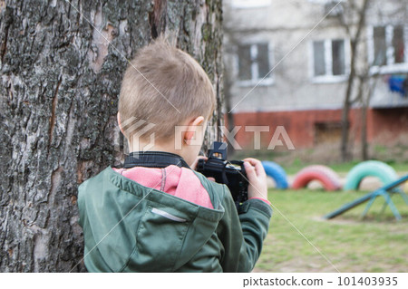 kid on the street in a jacket with an film camera. High quality photo kid on the street in a jacket with an film camera. High quality photo 101403935
