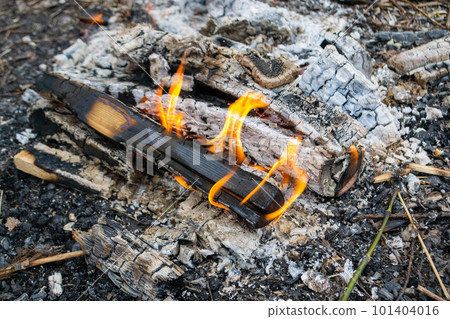 A fire burns in a campfire with a red fire in the background. High quality photo A fire burns in a campfire with a red fire in the background. High quality photo 101404016