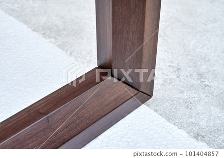 Wooden frame of bedside table made of solid walnut in workshop. Joinery angular joint of planks on dowels closeup 101404857