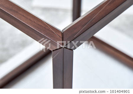 Wooden frame of bedside table made of solid walnut in workshop. Joinery angular joint of planks on dowels closeup Wooden frame of bedside table made of solid walnut in workshop. Joinery angular joint of planks on dowels closeup 101404901