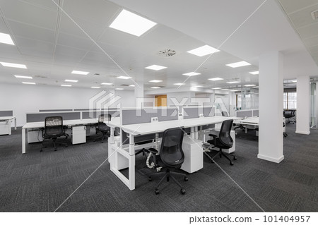 An empty gray call center office with tables and chairs after the bankruptcy of a large banking company. Concept of crisis and shortage of jobs An empty gray call center office with tables and chairs after the bankruptcy of a large banking company. Concept of crisis and shortage of jobs 101404957