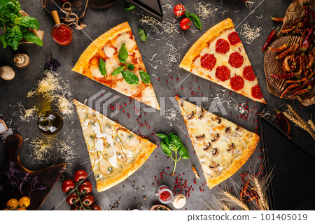 Assorted pizza slices with different toppings 101405019