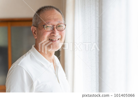 Smiling elderly man relaxing at home Smiling elderly man relaxing at home 101405066