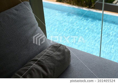 gray pillow put on bed, pool view 101405524