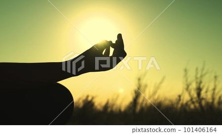 Yoga sunset girl sitting pose silhouette woman. sun hand exercise stretching sport park nature health breathe sky beach lifestyle pray. meditation unrecognizable activity position energy. yogi 101406164