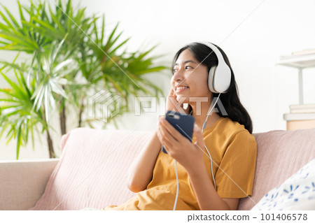 Asian teenager listen to music on smartphone with headphone enjoy. 101406578