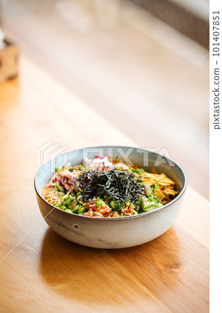 Portion of poke bowl dish on the table Portion of poke bowl dish on the table 101407851