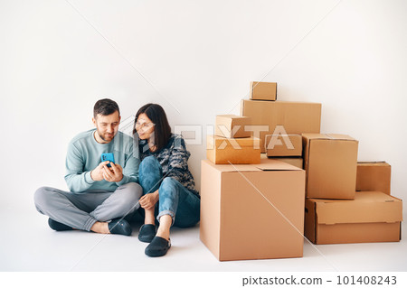 Young married couple plans home improvement projects in their new apartment on moving day Young married couple plans home improvement projects in their new apartment on moving day 101408243