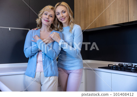 Loving adult daughter embracing her female parent 101408412
