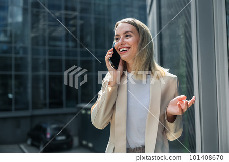 Cute blonde elegant woman talking on the phone Cute blonde elegant woman talking on the phone 101408670