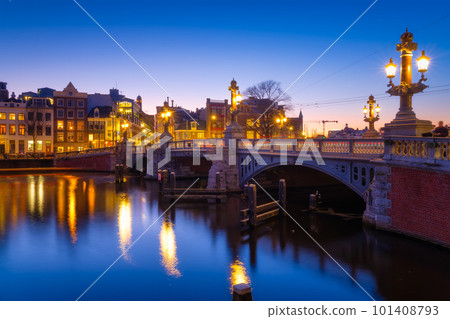 Blue bridge, Amsterdam, Netherlands. Blauwbrug. Evening cityscape. Blue sky and city lights. Blue bridge, Amsterdam, Netherlands. Blauwbrug. Evening cityscape. Blue sky and city lights. 101408793