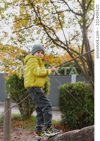Funny cute happy baby playing on the playground. The emotion of happiness, fun, joy. Smile of a child. boy playing on the playground Funny cute happy baby playing on the playground. The emotion of happiness, fun, joy. Smile of a child. boy playing on the playground 101409320