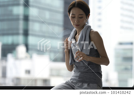 Woman resting after training hydration workout 101410242