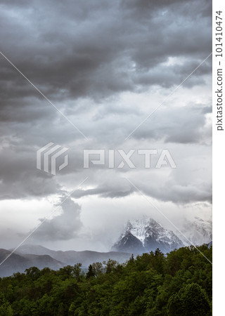 Landscape image of cloudy sky over snowy mountains Landscape image of cloudy sky over snowy mountains 101410474