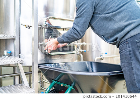 cleaning the boiler from residual malt after brewing beer in the brewery 101410644