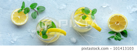 Lemonade with mint panorama. Lemon water drink with ice. Two glasses 101413103