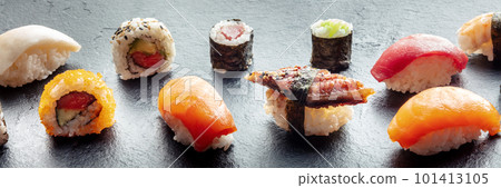 Sushi panorama. Nigiri with eel, salmon and tuna, roll with avocado etc Sushi panorama. Nigiri with eel, salmon and tuna, roll with avocado etc 101413105